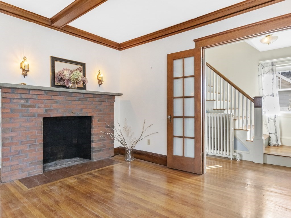 149 Trapelo Road Waltham, MA 02452 - Photo 13 of 36 a view of a livingroom with wooden floor and a fireplace