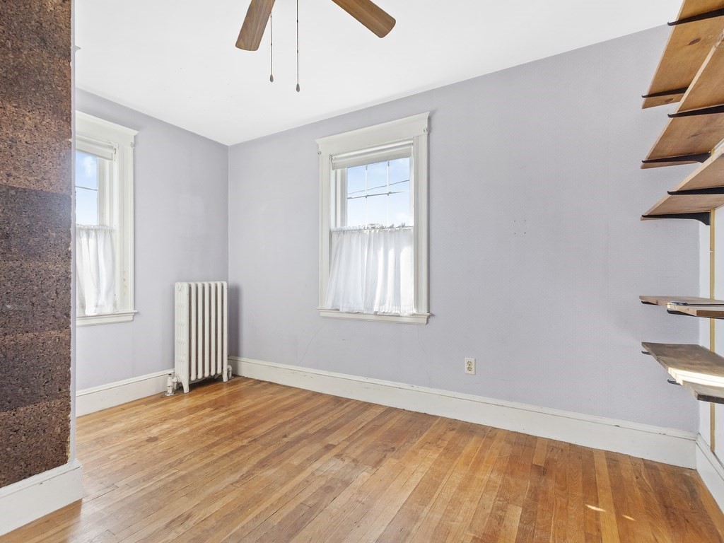 149 Trapelo Road Waltham, MA 02452 - Photo 19 of 36 a view of empty room with wooden floor and fan