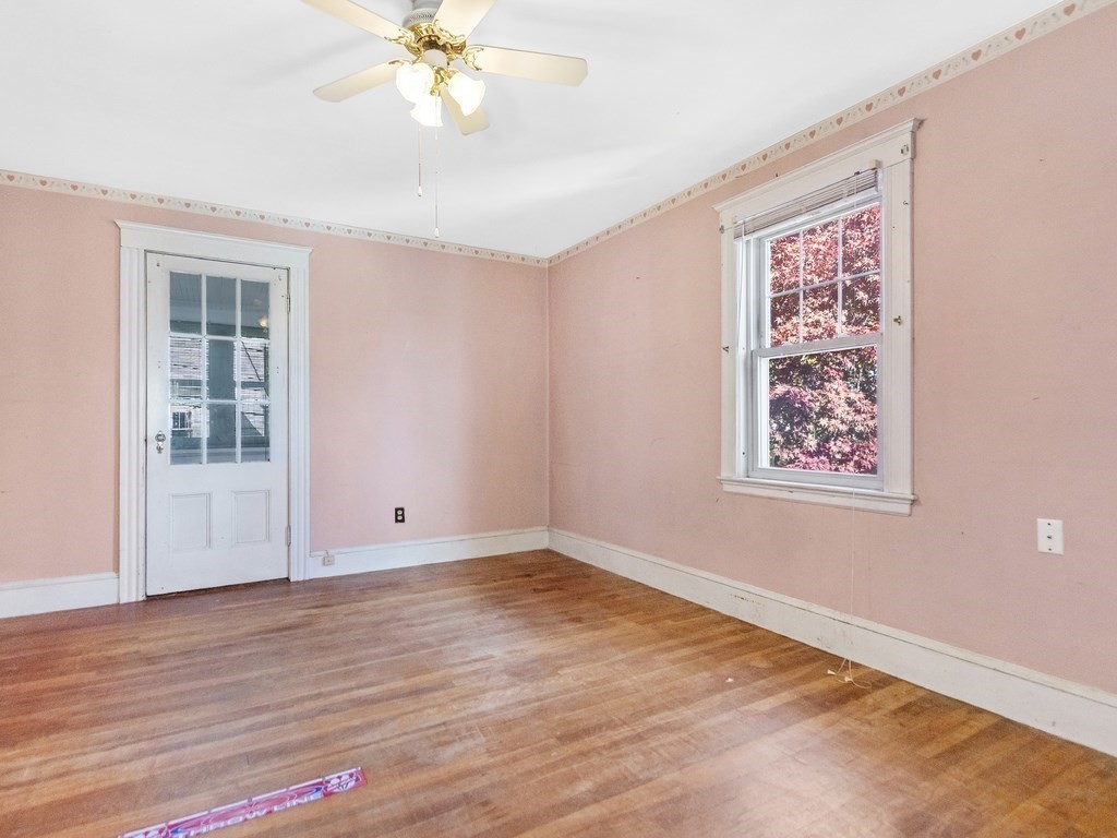 149 Trapelo Road Waltham, MA 02452 - Photo 25 of 36 a view of an empty room with wooden floor and a window