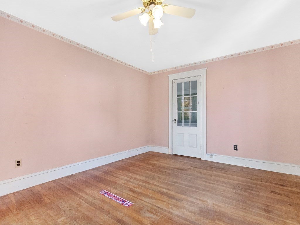 149 Trapelo Road Waltham, MA 02452 - Photo 26 of 36 a view of an empty room with wooden floor and a chandelier fan