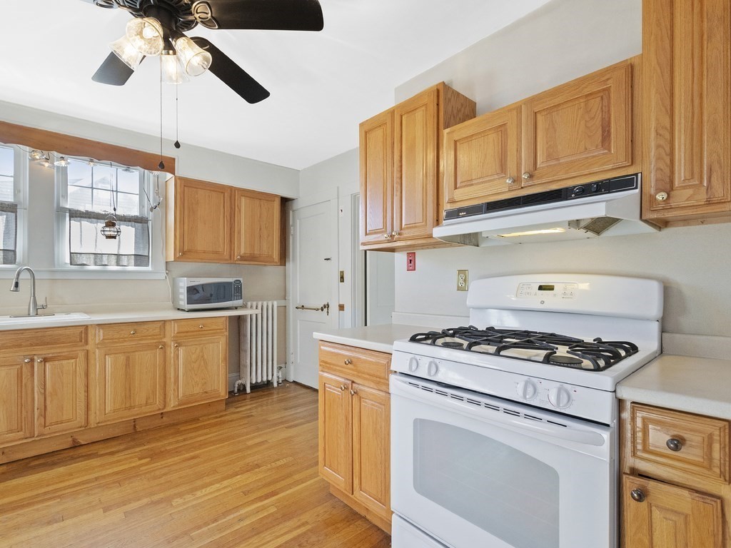 149 Trapelo Road Waltham, MA 02452 - Photo 5 of 36 a kitchen with stainless steel appliances granite countertop a stove a sink and white cabinets