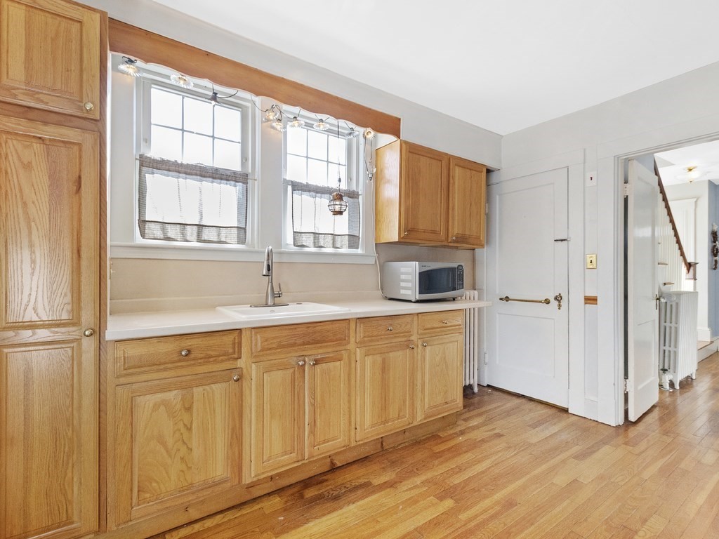 149 Trapelo Road Waltham, MA 02452 - Photo 8 of 36 a kitchen with granite countertop a sink cabinets and a window