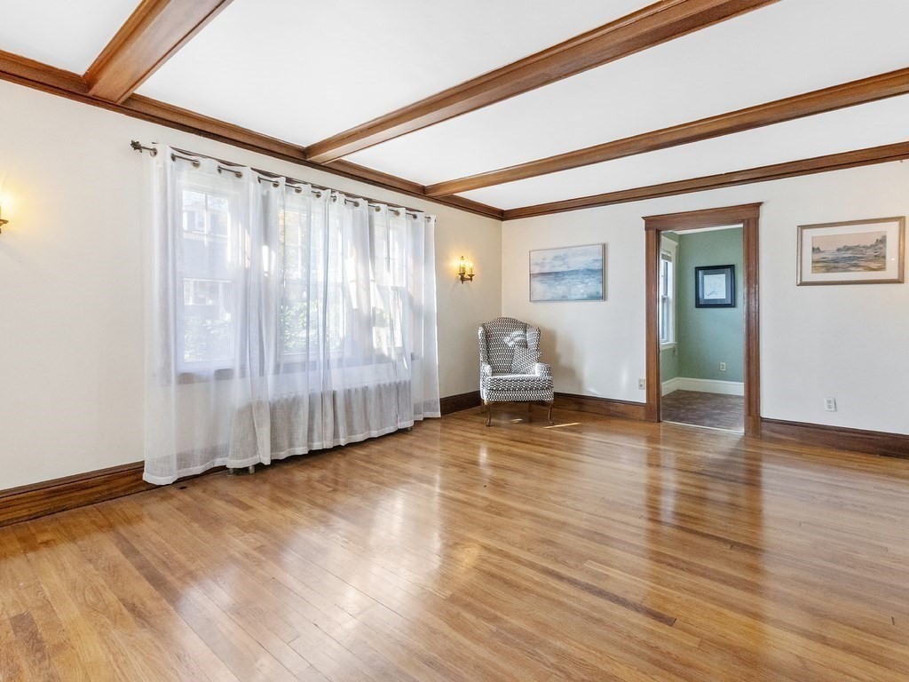 149 Trapelo Road Waltham, MA 02452 - Photo 9 of 36 a view of an empty room with wooden floor and a window