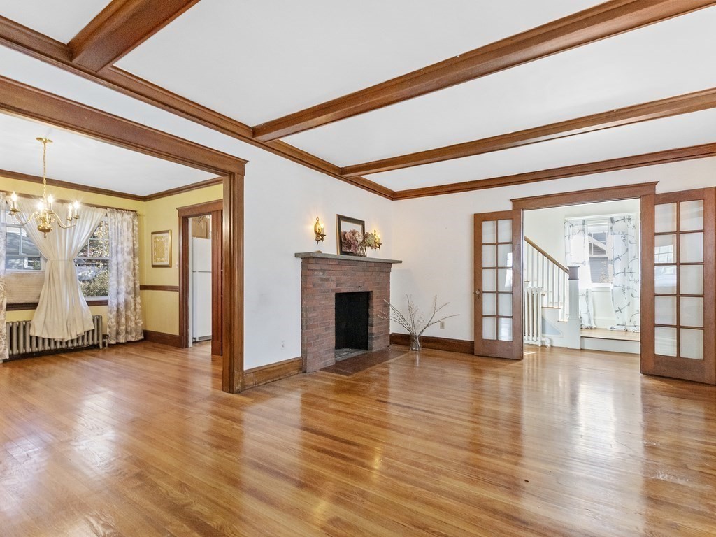 149 Trapelo Road Waltham, MA 02452 - Photo 10 of 36 a view of a livingroom with wooden floor and fireplace
