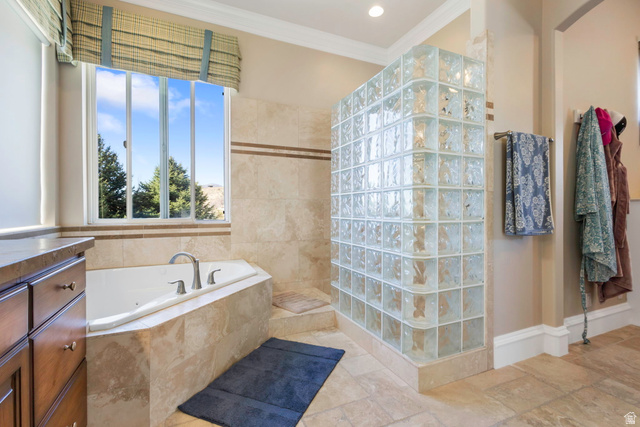 684 North Summit Way Alpine, UT 84004 - Photo 35 of 58 Bathroom featuring a walk in shower, crown molding, a bath, vanity, and stone tile floors