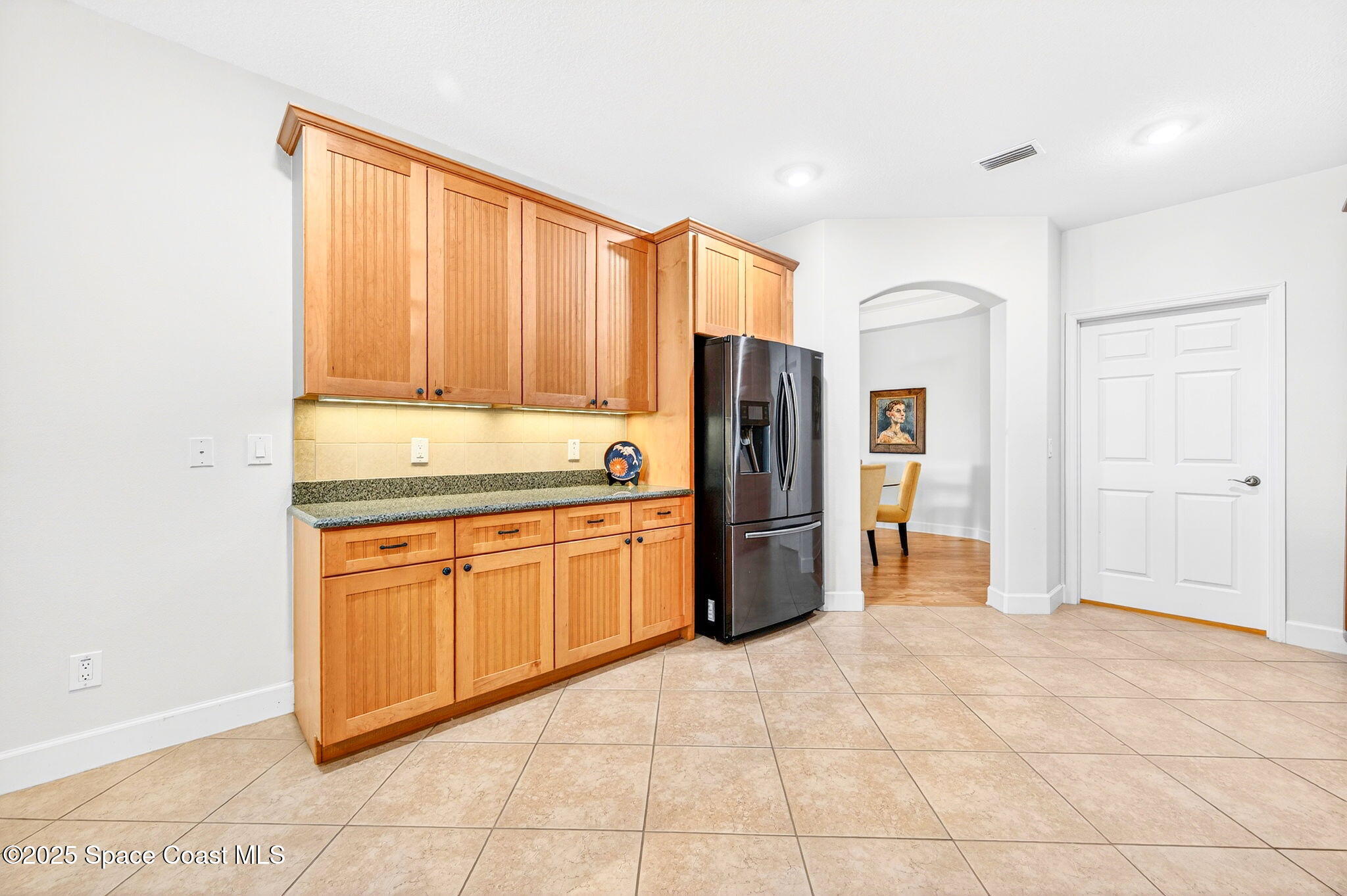 3407 Bancroft Drive Melbourne, FL 32940 - Photo 14 of 74 a kitchen with stainless steel appliances granite countertop a refrigerator and a sink