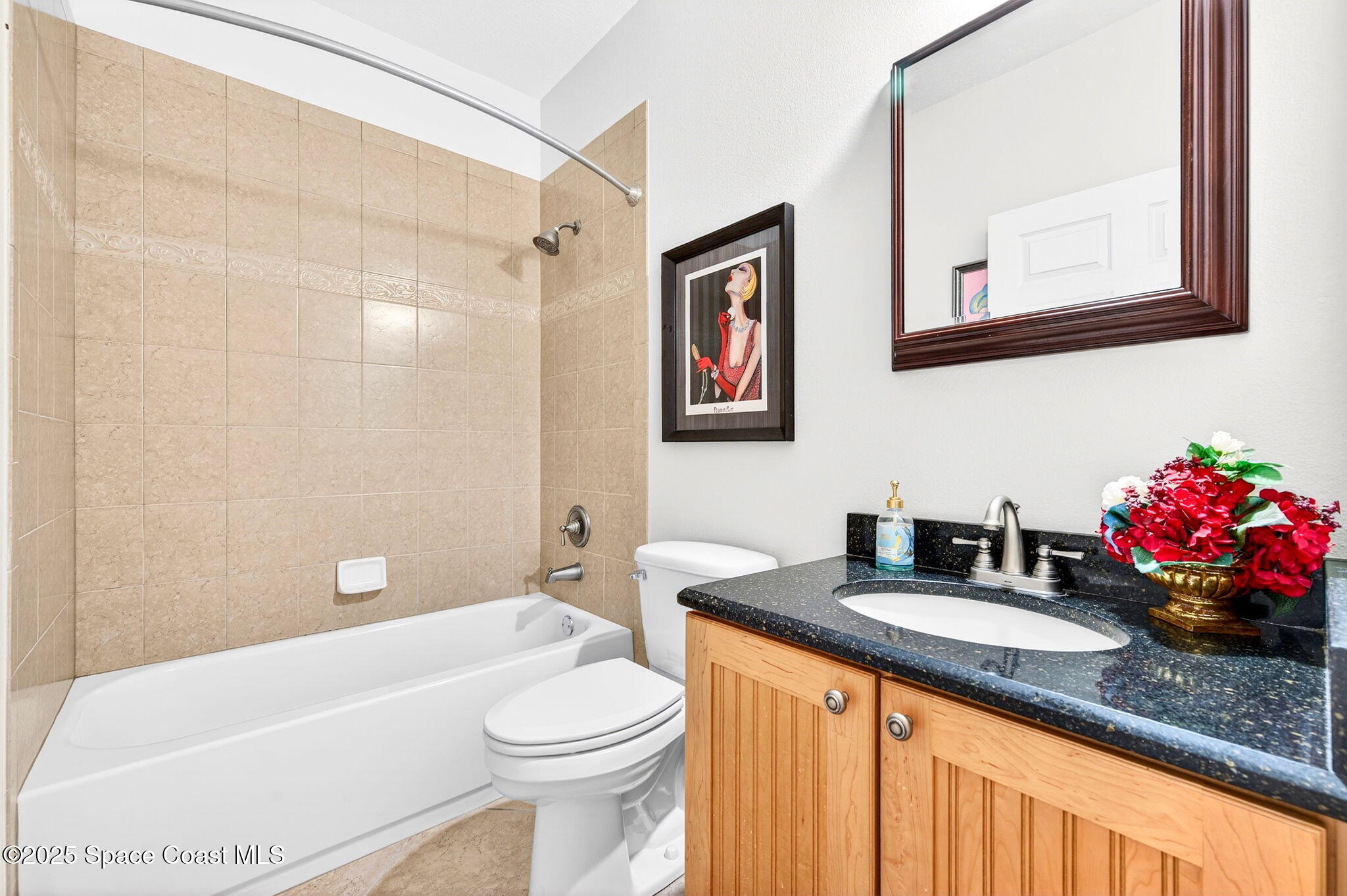3407 Bancroft Drive Melbourne, FL 32940 - Photo 30 of 74 a bathroom with a granite countertop sink mirror vanity bathtub and toilet