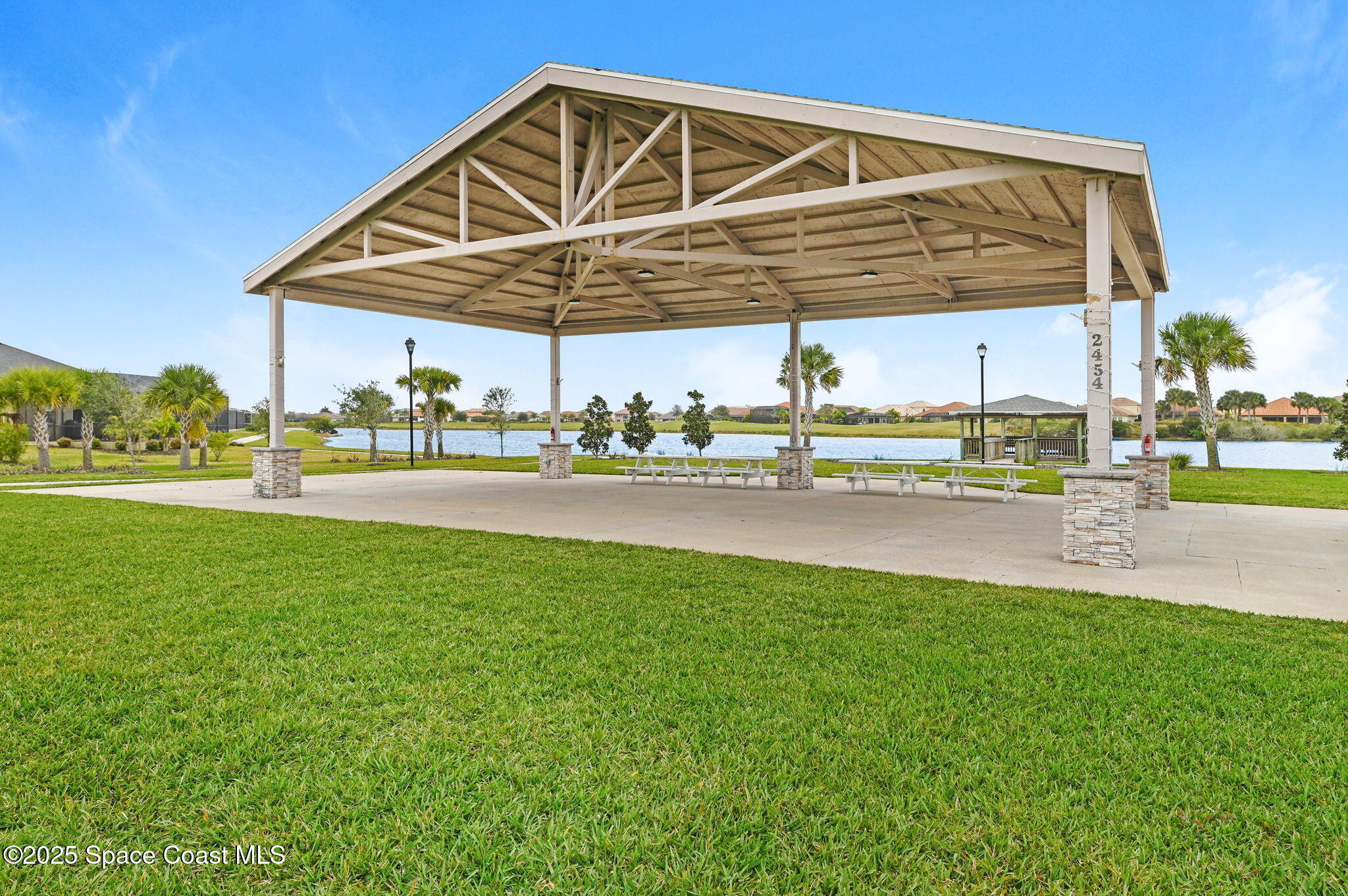 3407 Bancroft Drive Melbourne, FL 32940 - Photo 48 of 74 a view of a lawn chairs under an umbrella