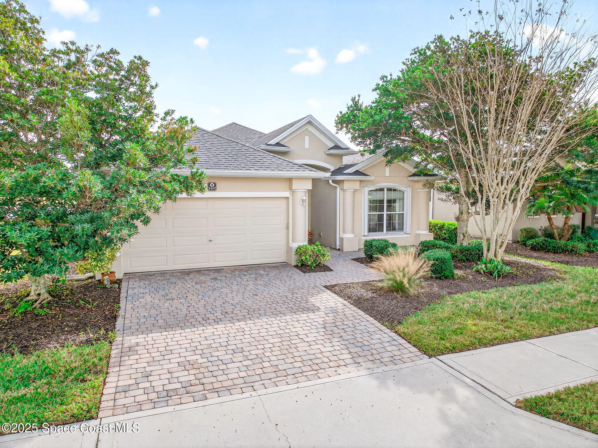 3407 Bancroft Drive Melbourne, FL 32940 - Photo 52 of 74 a front view of a house with a yard and a garage