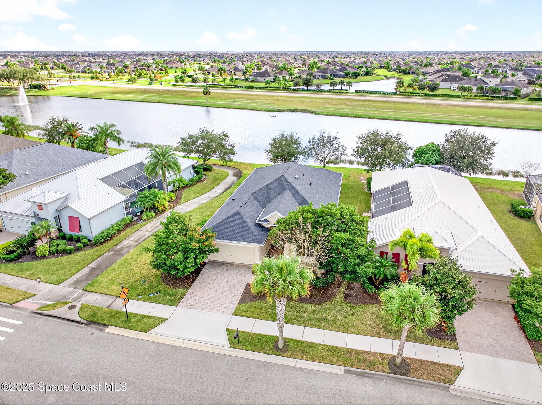 3407 Bancroft Drive Melbourne, FL 32940 - Photo 57 of 74 an aerial view of a house with a garden and lake view