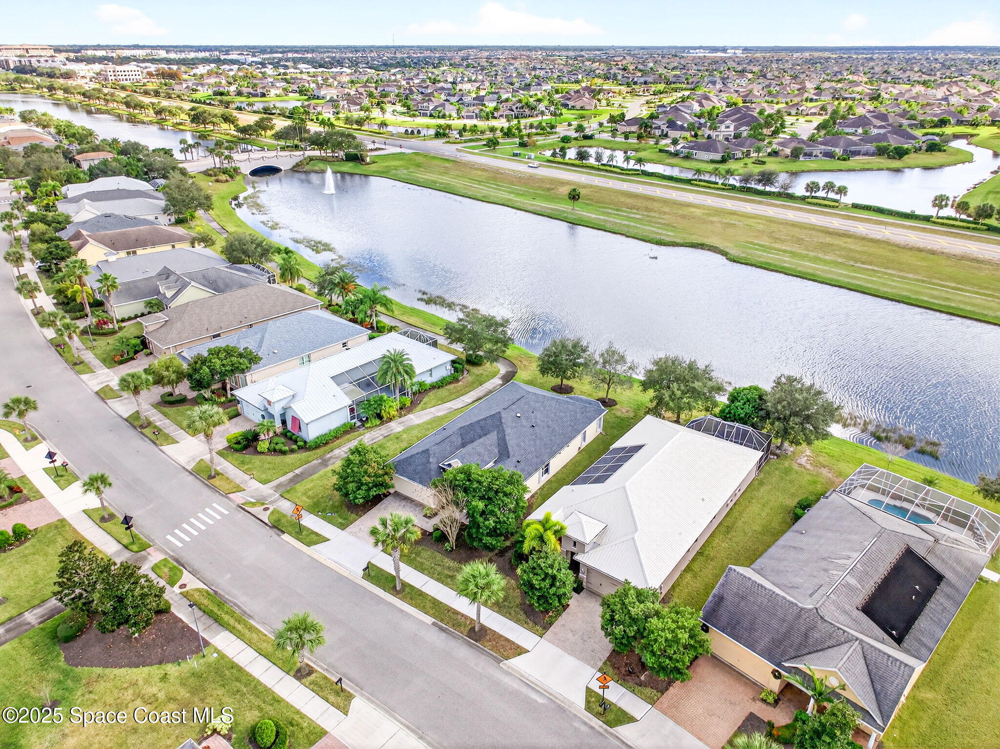 3407 Bancroft Drive Melbourne, FL 32940 - Photo 61 of 74 an aerial view of a city with a lake