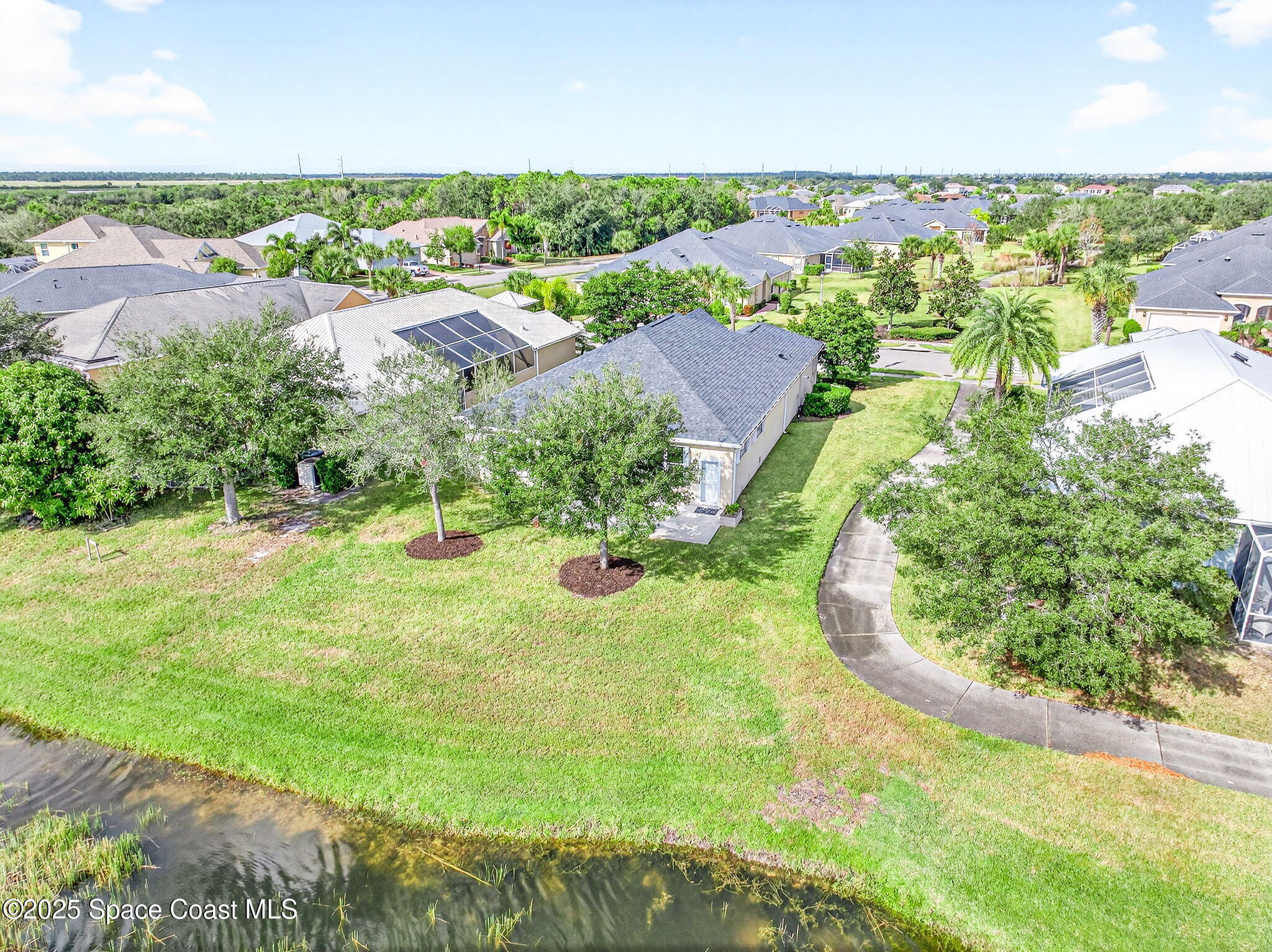 3407 Bancroft Drive Melbourne, FL 32940 - Photo 65 of 74 an aerial view of residential houses with outdoor space and trees