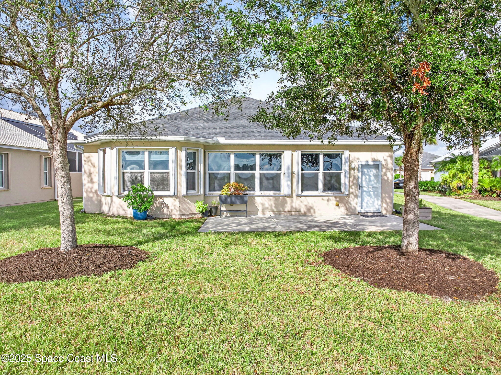 3407 Bancroft Drive Melbourne, FL 32940 - Photo 68 of 74 a front view of a house with a yard table and chairs