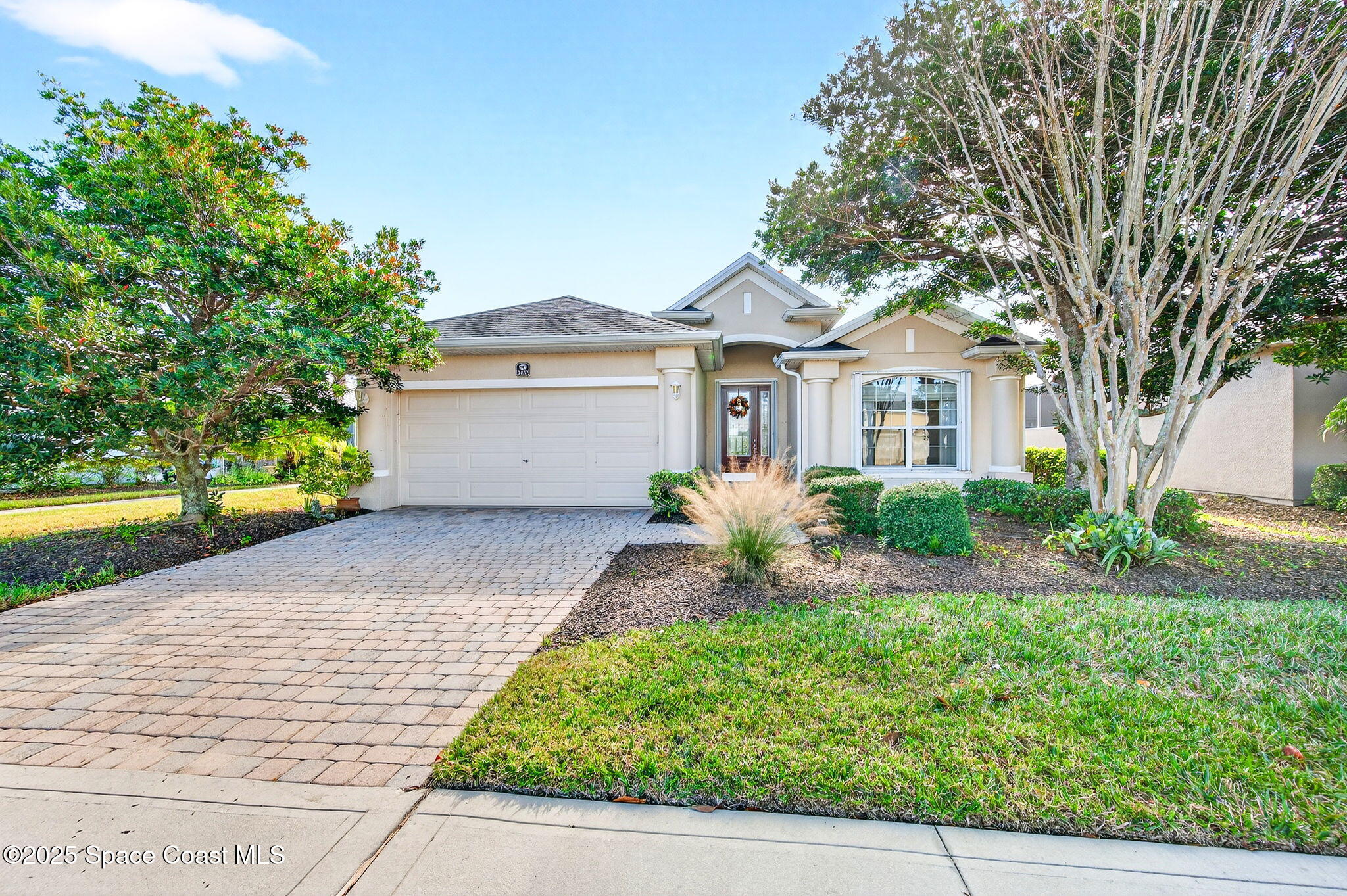 3407 Bancroft Drive Melbourne, FL 32940 - Photo 73 of 74 a front view of a house with a yard and a garage