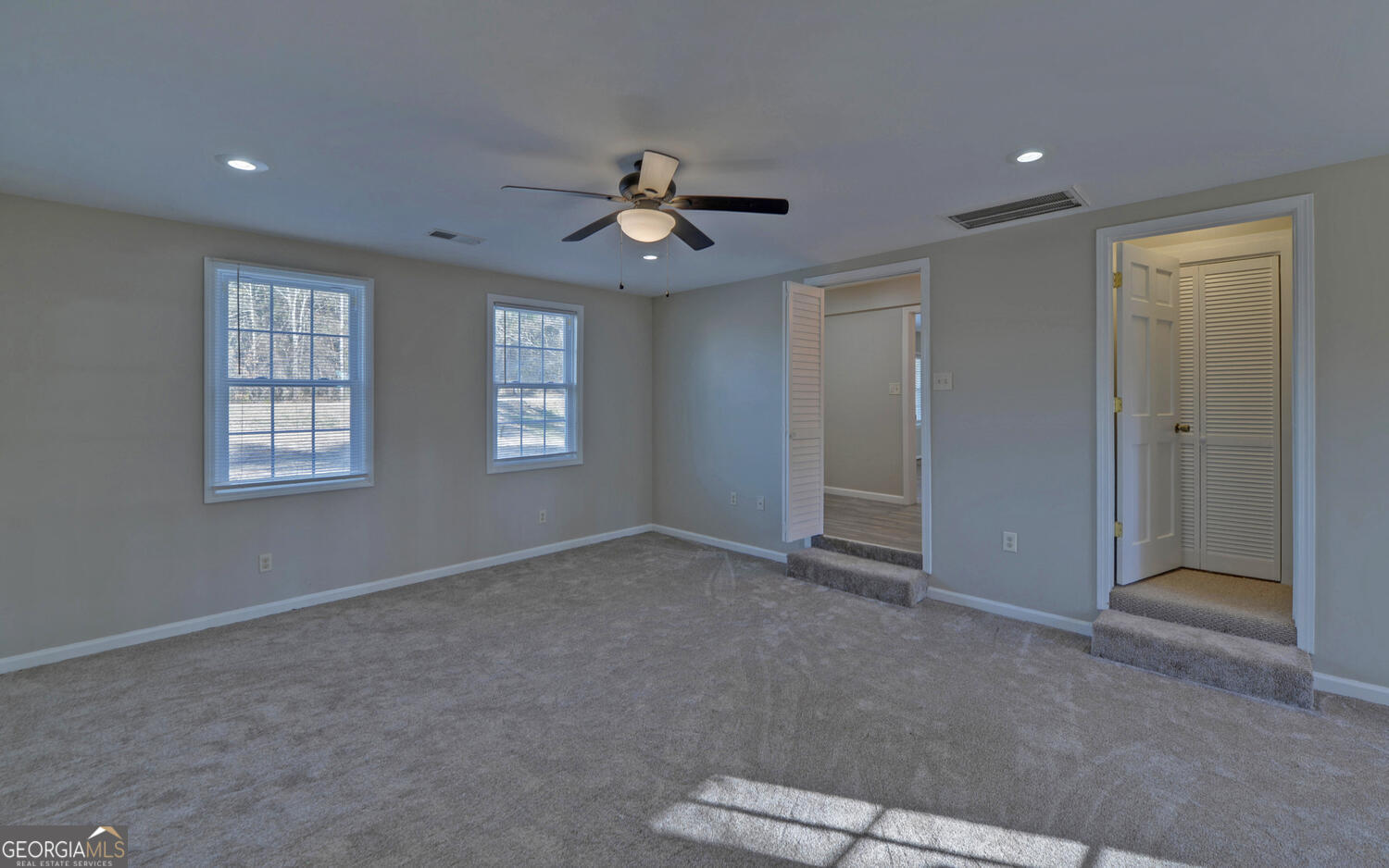 297 East Leatherwood Road Toccoa, GA 30577 - Photo 11 of 37 an empty room with windows and ceiling fan