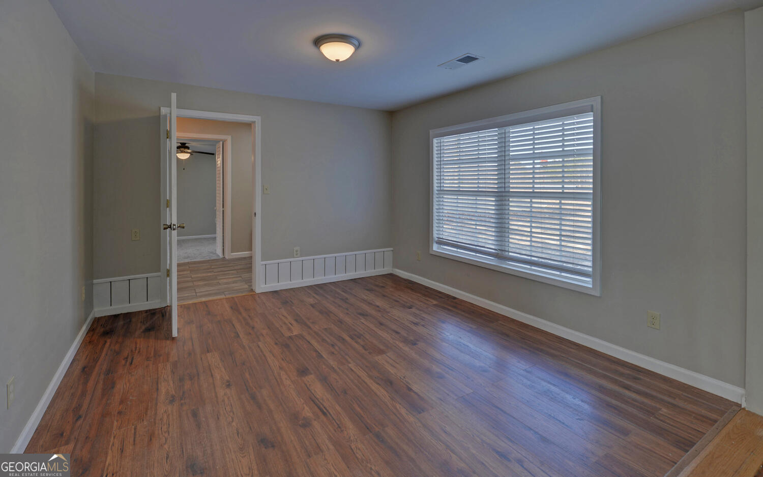 297 East Leatherwood Road Toccoa, GA 30577 - Photo 13 of 37 an empty room with wooden floor and windows
