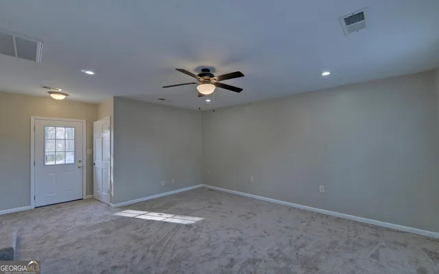an empty room with windows and closet