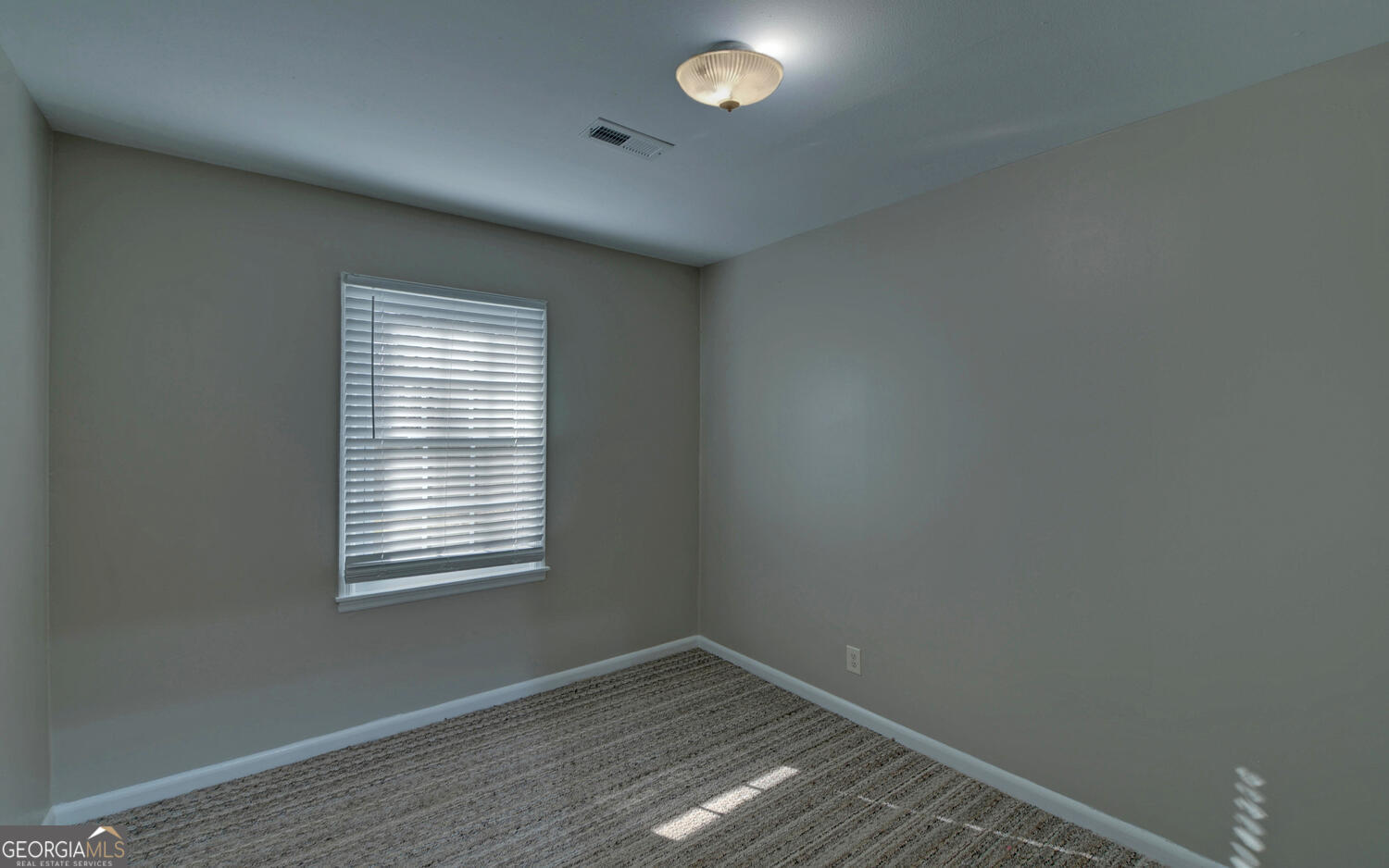 297 East Leatherwood Road Toccoa, GA 30577 - Photo 29 of 37 an empty room with wooden floor and windows