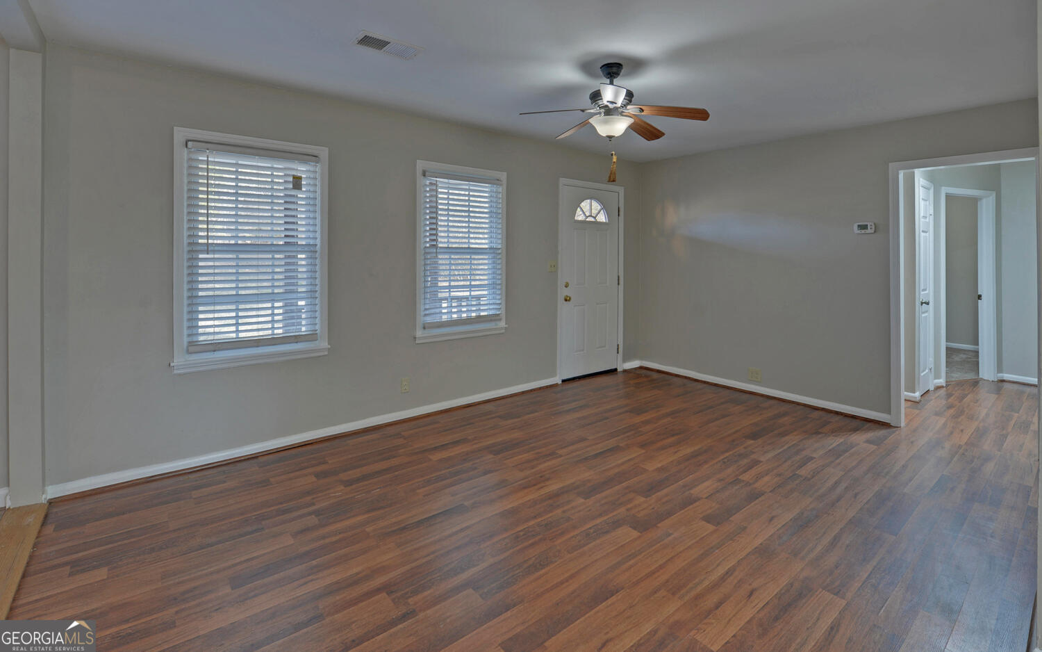 297 East Leatherwood Road Toccoa, GA 30577 - Photo 10 of 37 a view of an empty room with wooden floor and a window