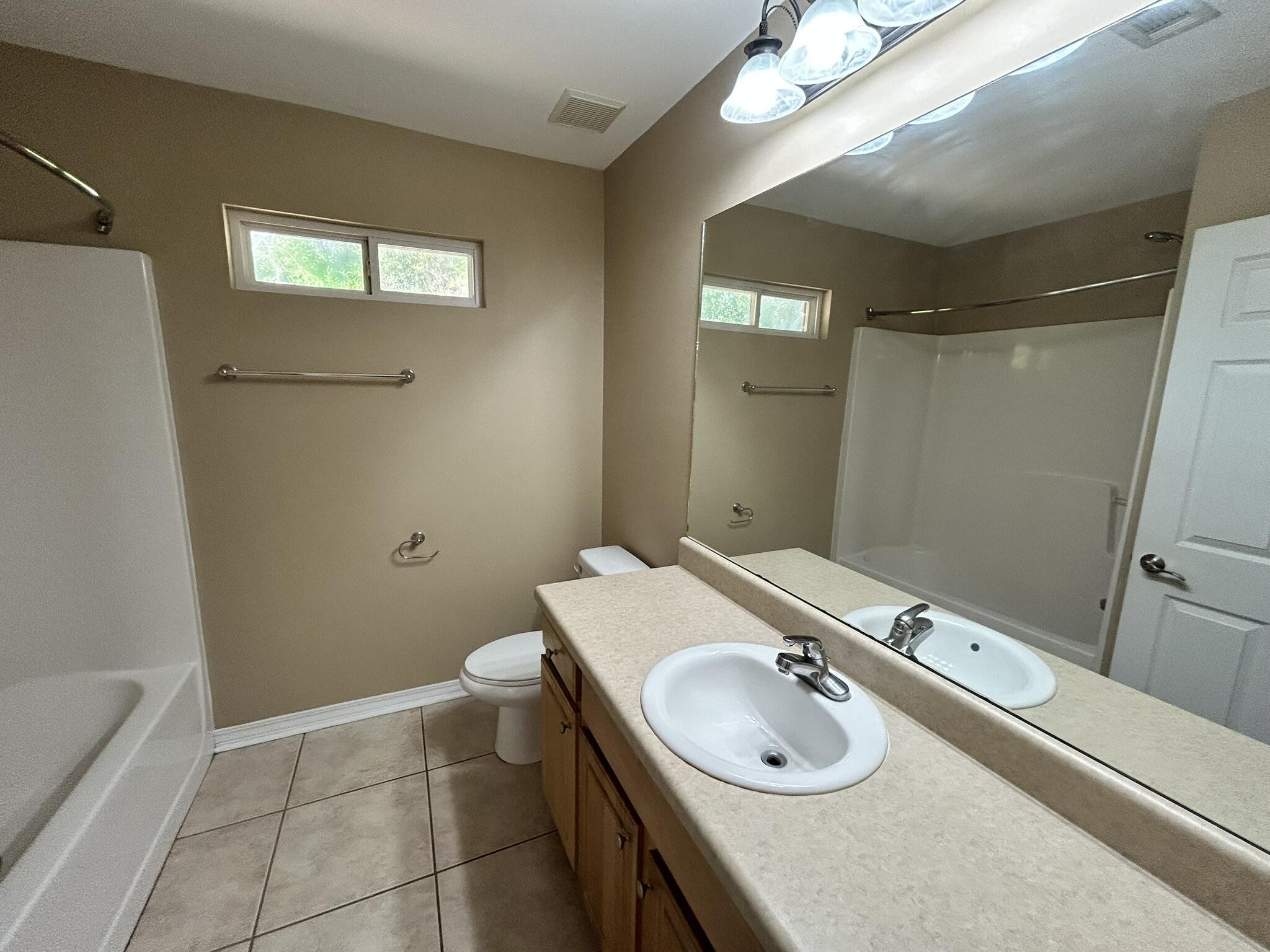 5819 Roberts Road Crestview, FL 32536 - Photo 11 of 15 a bathroom with a sink and a mirror