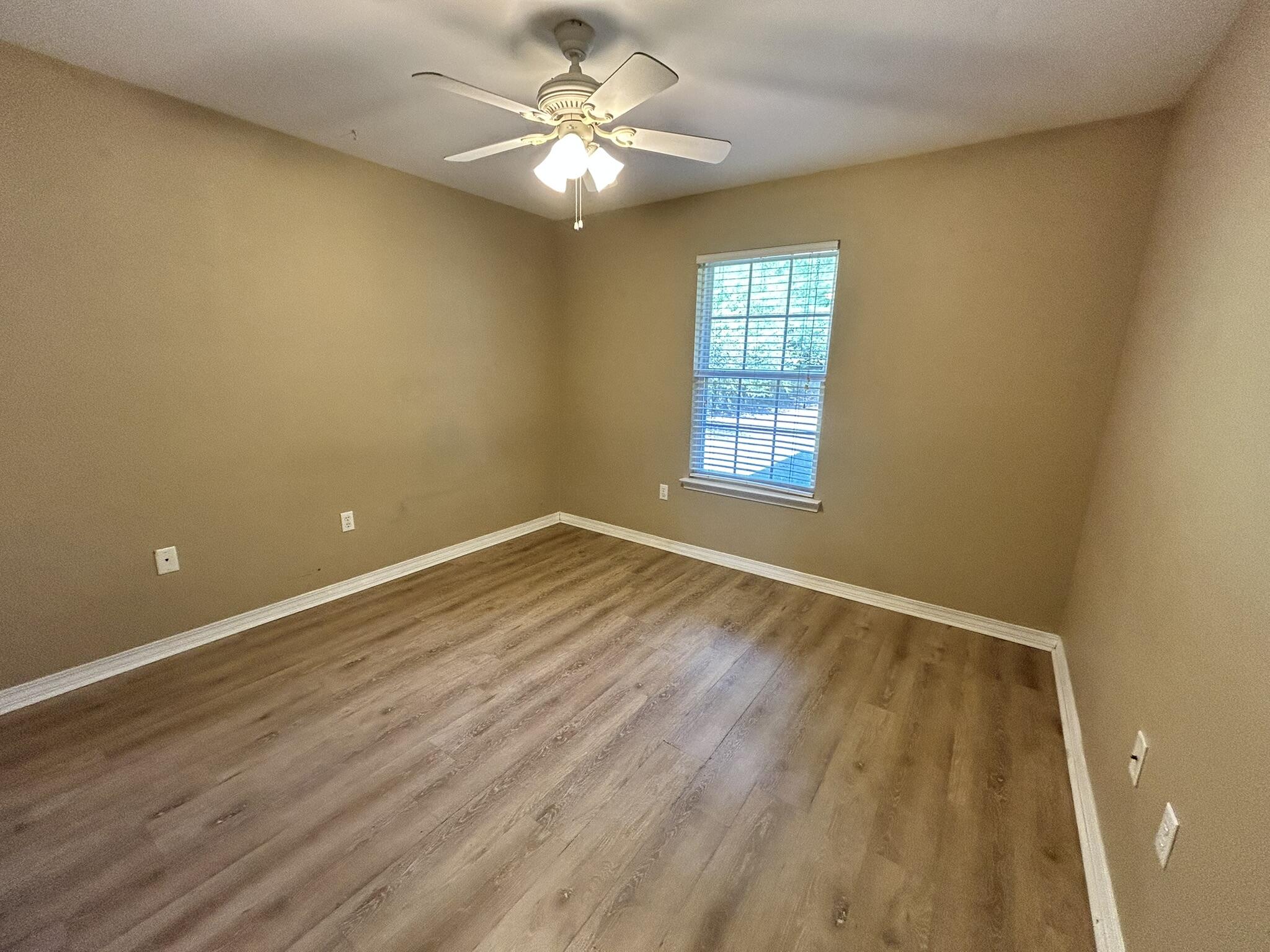 5819 Roberts Road Crestview, FL 32536 - Photo 12 of 15 a view of empty room with wooden floor and fan