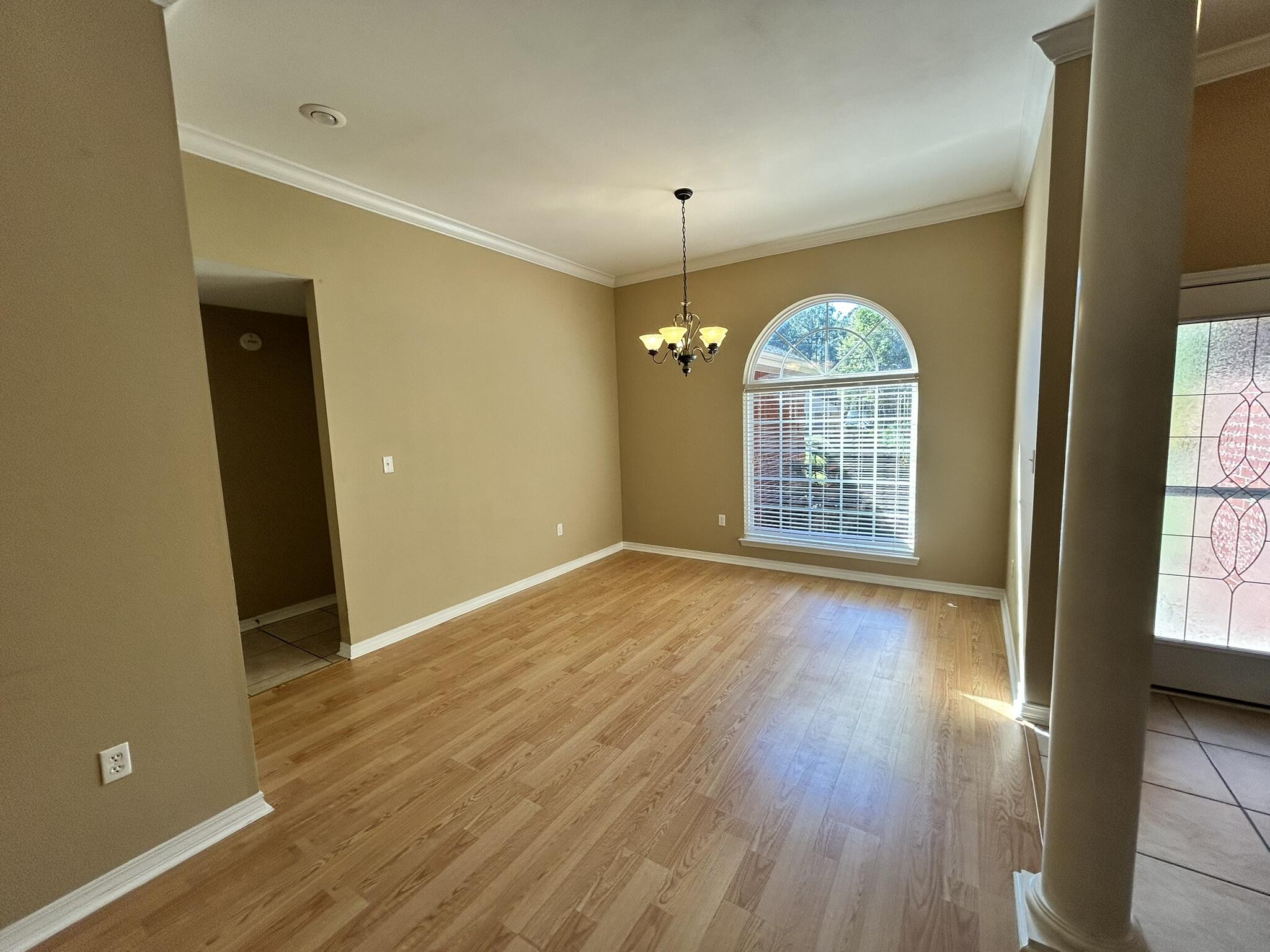 5819 Roberts Road Crestview, FL 32536 - Photo 3 of 15 a view of an empty room with a window and wooden floor