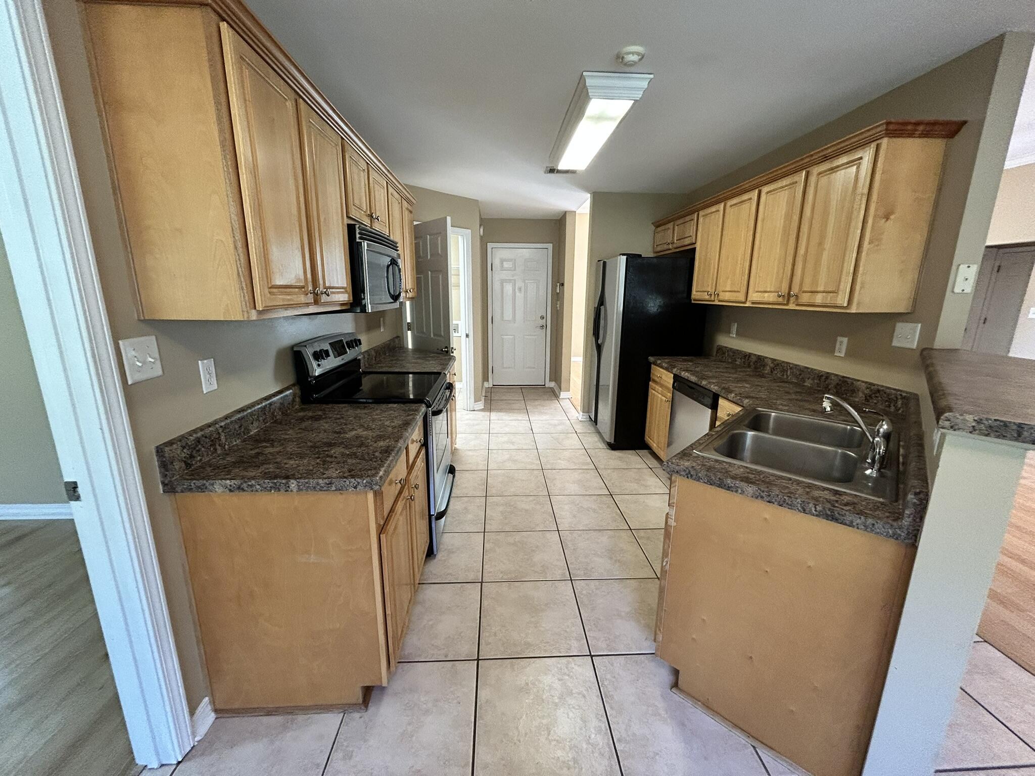 5819 Roberts Road Crestview, FL 32536 - Photo 5 of 15 a kitchen with stainless steel appliances granite countertop a stove a sink and a refrigerator