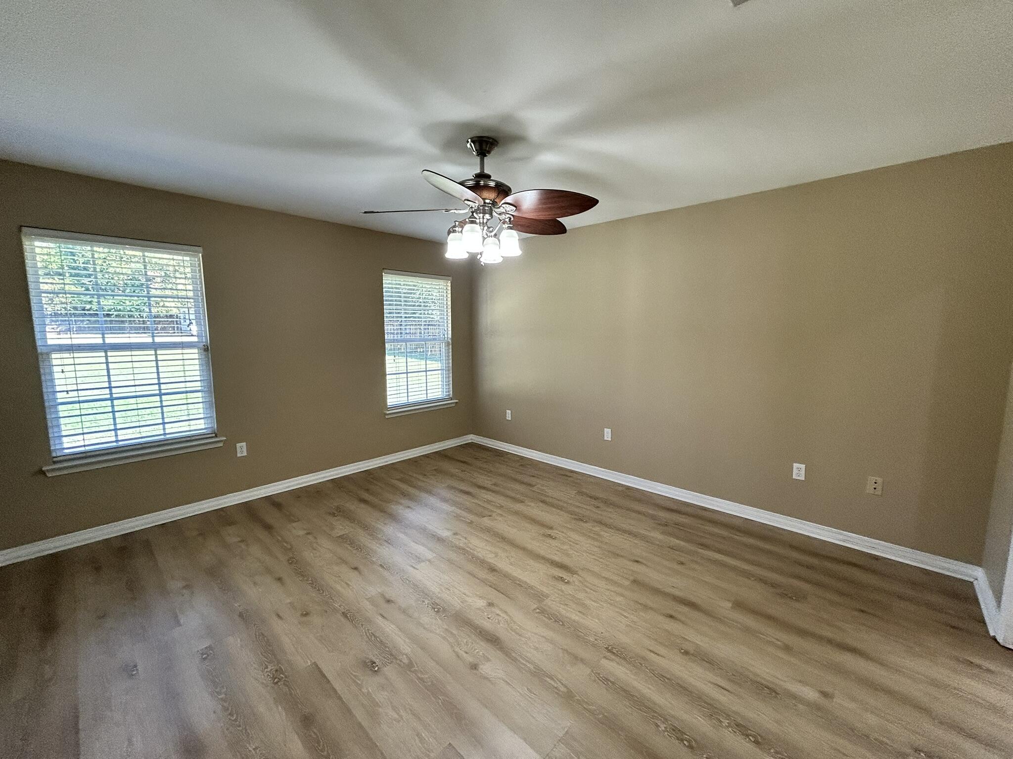 5819 Roberts Road Crestview, FL 32536 - Photo 7 of 15 wooden floor in an empty room with a window