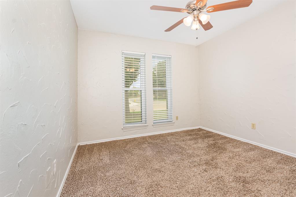 229 South Heartz Road Coppell, TX 75019 - Photo 14 of 18 Carpeted empty room featuring ceiling fan and a textured wall