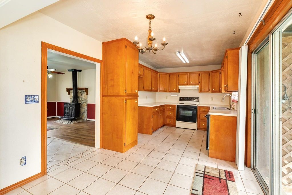 404 Chestnut Street Brazoria, TX 77422 - Photo 8 of 23 a kitchen with stainless steel appliances kitchen island granite countertop a refrigerator and a sink
