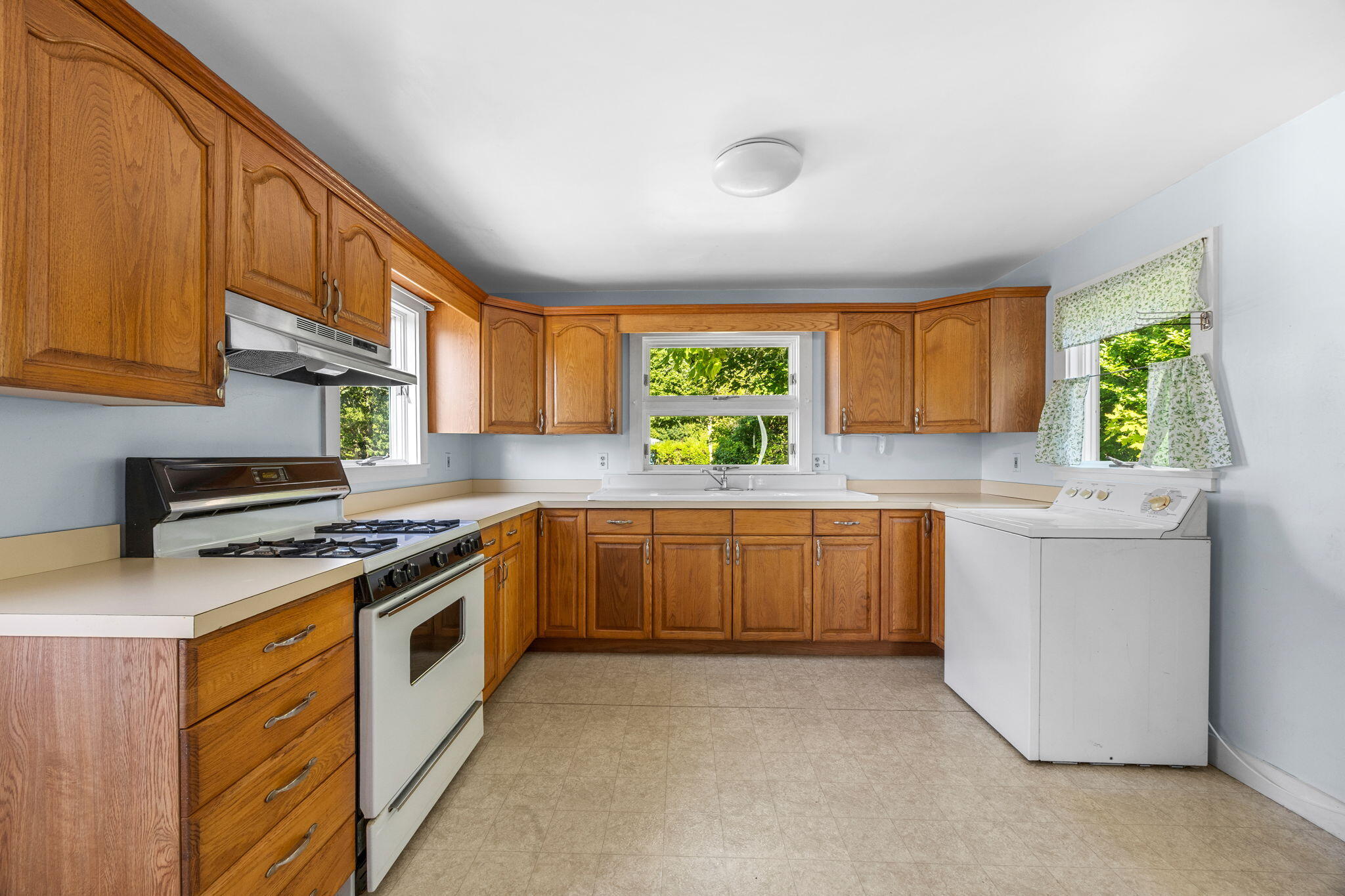 9 Harrison Avenue Buzzards Bay, MA 02532 - Photo 13 of 47 a kitchen with a sink stove and cabinets