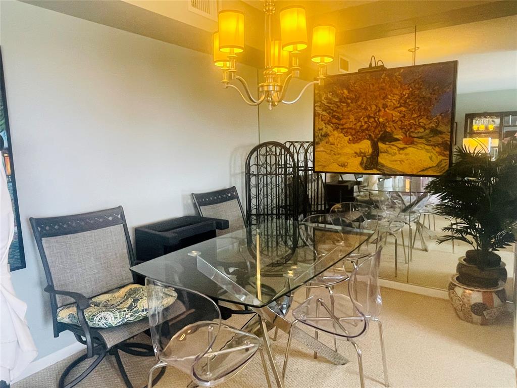 2500 Northeast 48th Lane, Unit 605 Fort Lauderdale, FL 33308 - Photo 14 of 32 a view of a dining room with furniture and wooden floor