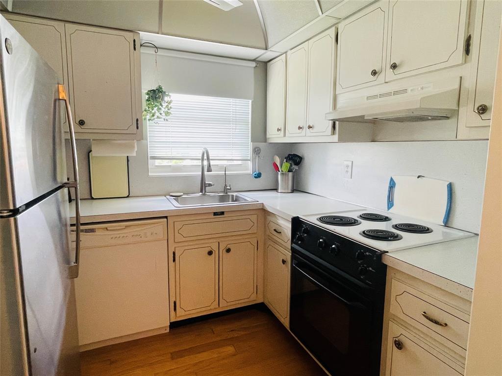 2500 Northeast 48th Lane, Unit 605 Fort Lauderdale, FL 33308 - Photo 16 of 32 a kitchen with stainless steel appliances granite countertop a sink stove and refrigerator
