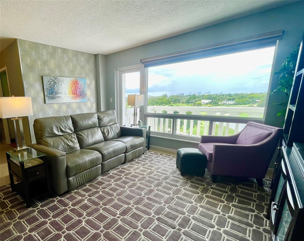 2500 Northeast 48th Lane, Unit 605 Fort Lauderdale, FL 33308 - Photo 21 of 32 a living room with furniture and a floor to ceiling window