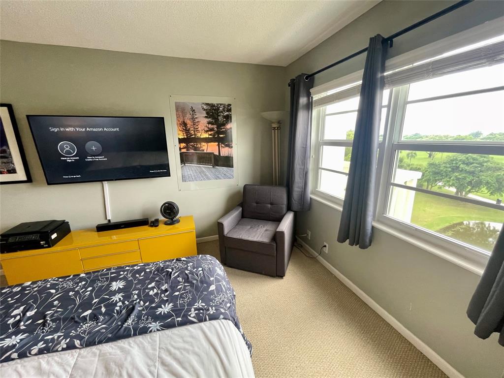 2500 Northeast 48th Lane, Unit 605 Fort Lauderdale, FL 33308 - Photo 24 of 32 a living room with furniture and a flat screen tv