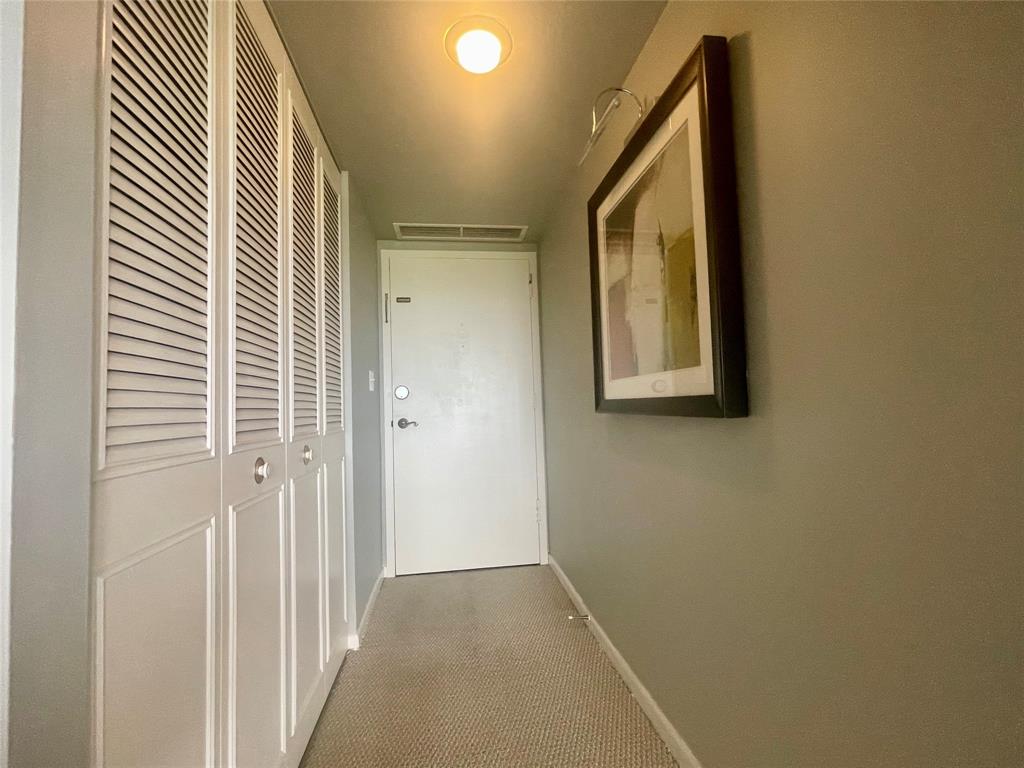 2500 Northeast 48th Lane, Unit 605 Fort Lauderdale, FL 33308 - Photo 26 of 32 a view of a hallway with wooden floor and entryway