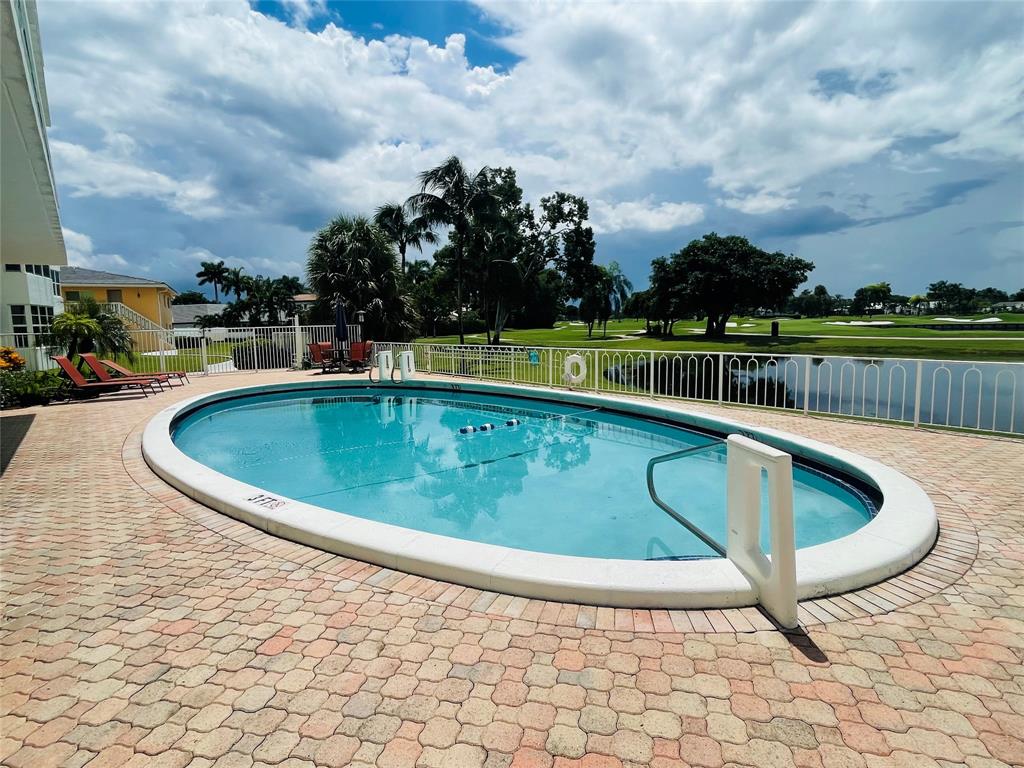 2500 Northeast 48th Lane, Unit 605 Fort Lauderdale, FL 33308 - Photo 27 of 32 a view of swimming pool with outdoor seating and plants