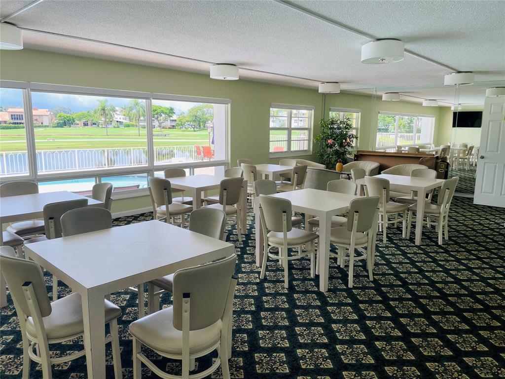 2500 Northeast 48th Lane, Unit 605 Fort Lauderdale, FL 33308 - Photo 31 of 32 a view of a dining room with furniture and wooden floor