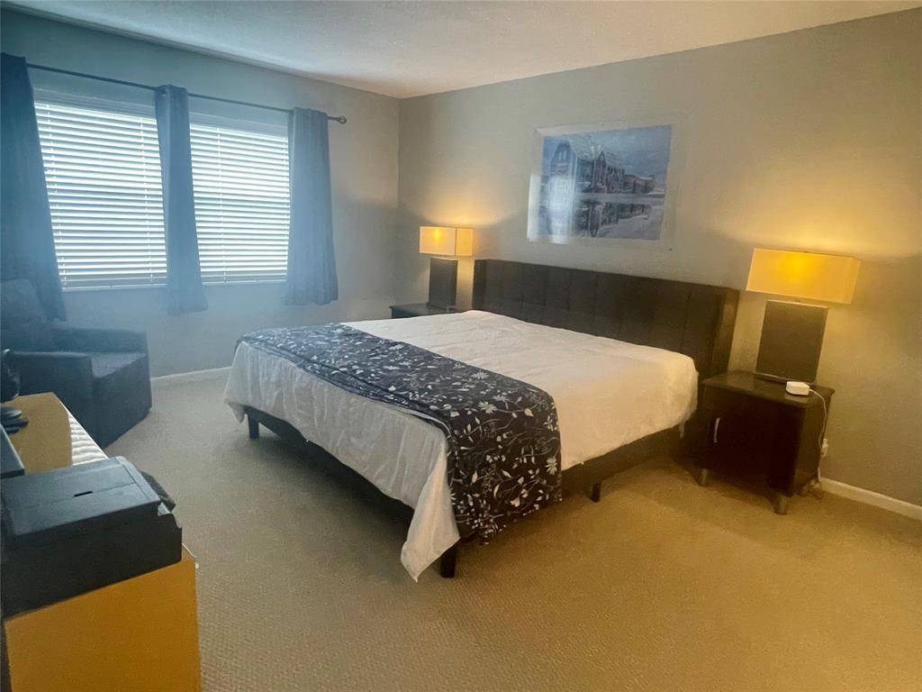 2500 Northeast 48th Lane, Unit 605 Fort Lauderdale, FL 33308 - Photo 4 of 32 a bedroom with a bed dresser and a window