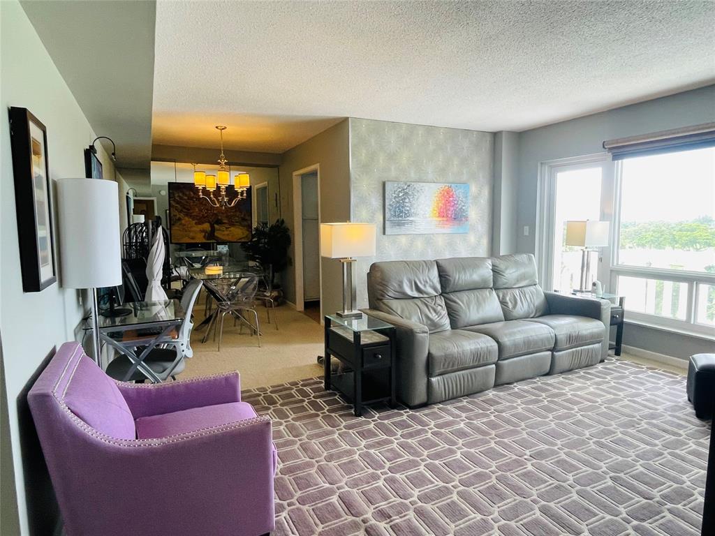 2500 Northeast 48th Lane, Unit 605 Fort Lauderdale, FL 33308 - Photo 10 of 32 a living room with furniture a window and a flat screen tv