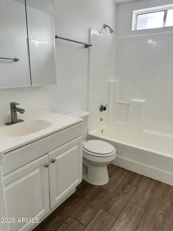 a bathroom with a toilet sink and shower