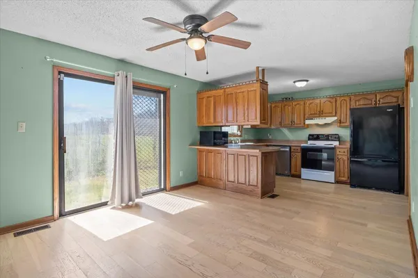 a kitchen with stainless steel appliances granite countertop a refrigerator and a sink