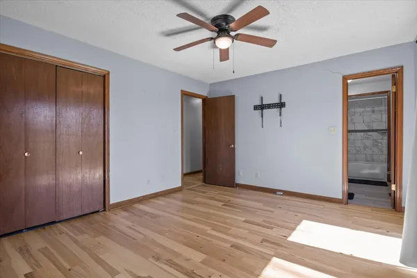 a view of a big room with wooden floor and closet area