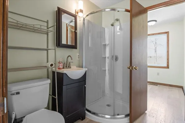 a bathroom with a sink toilet and shower