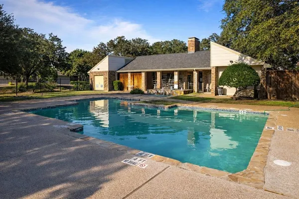 a front view of a house with a yard table and chairs