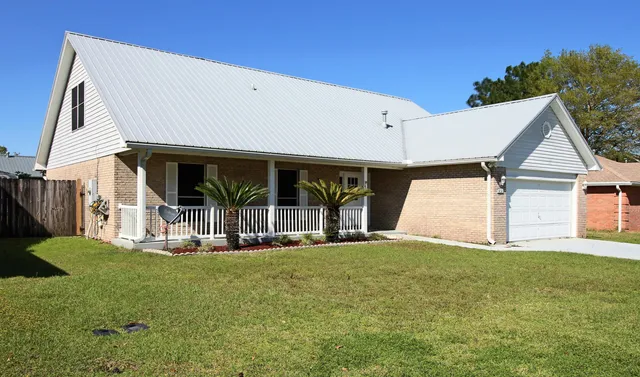 a view of a house with backyard and porch
