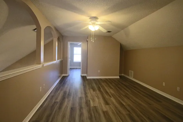 a view of hallway with wooden floor
