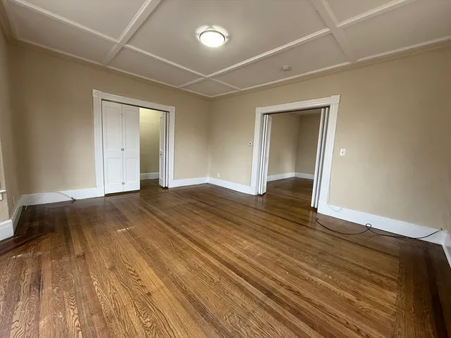 a view of an empty room and wooden floor
