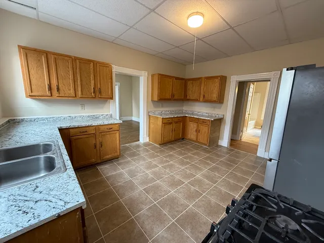 a kitchen with a sink and a stove top oven