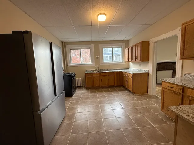 a large kitchen with a stove a refrigerator and a sink